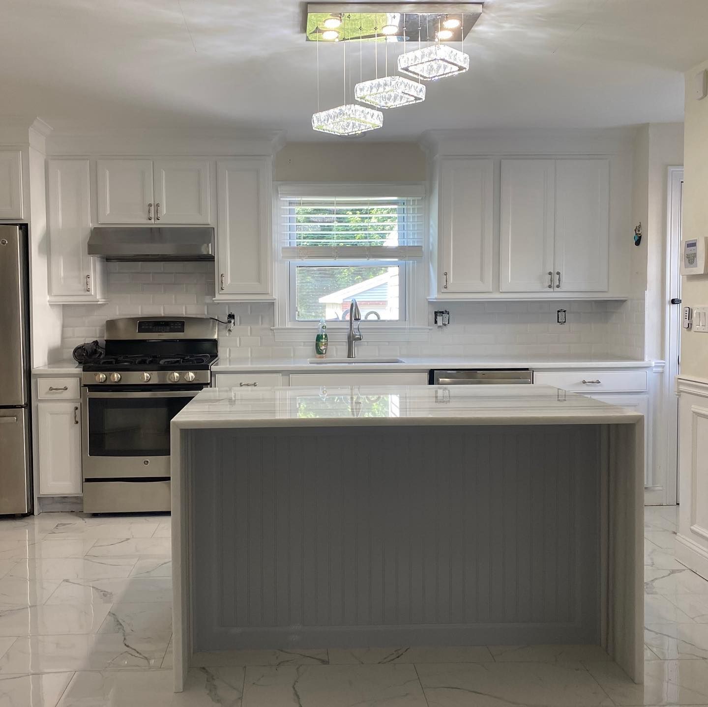 A kitchen with white cabinets and stainless steel appliances