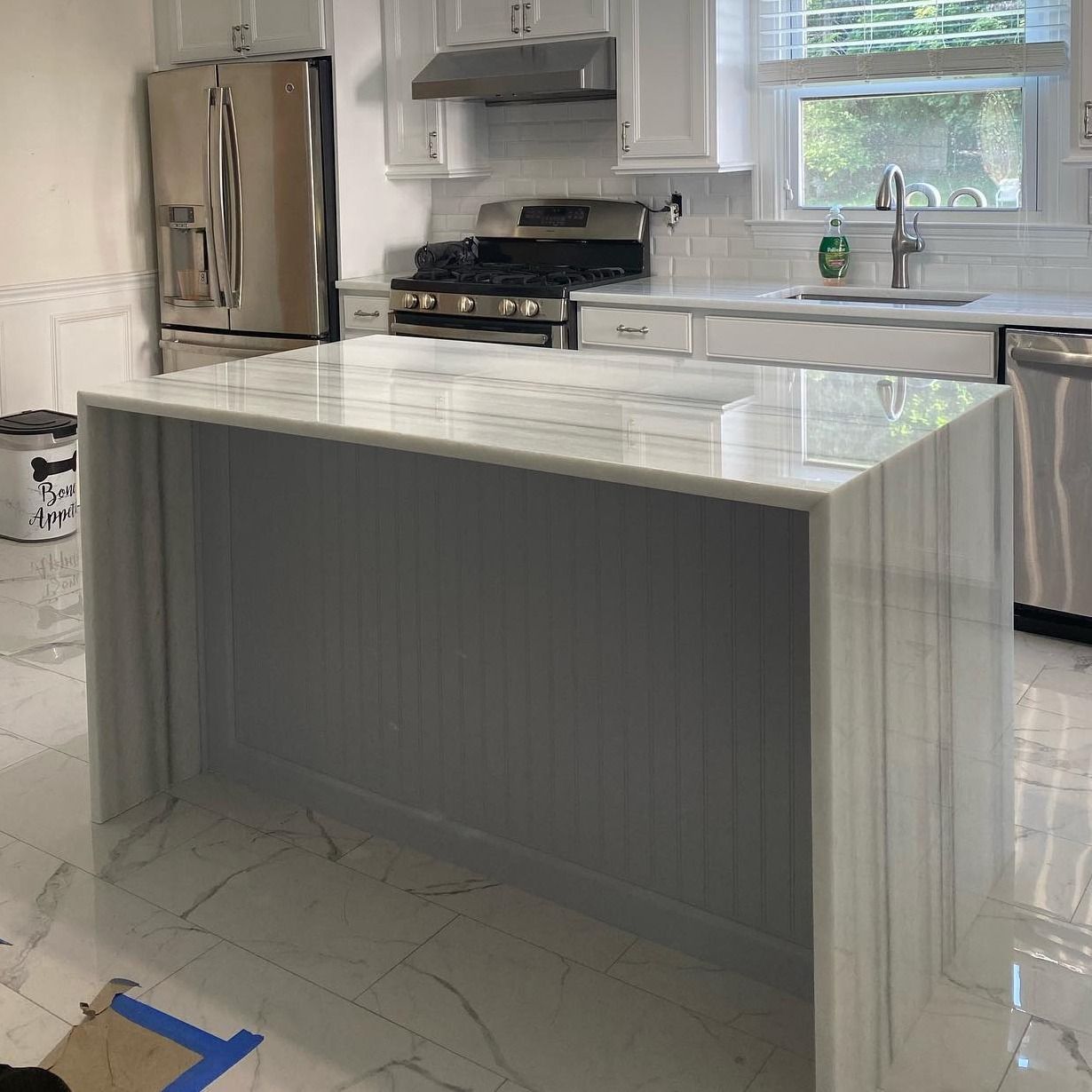 A kitchen with a large island in the middle