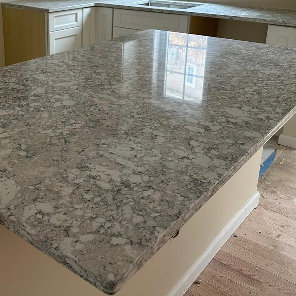 A kitchen with a large granite counter top and a sink.