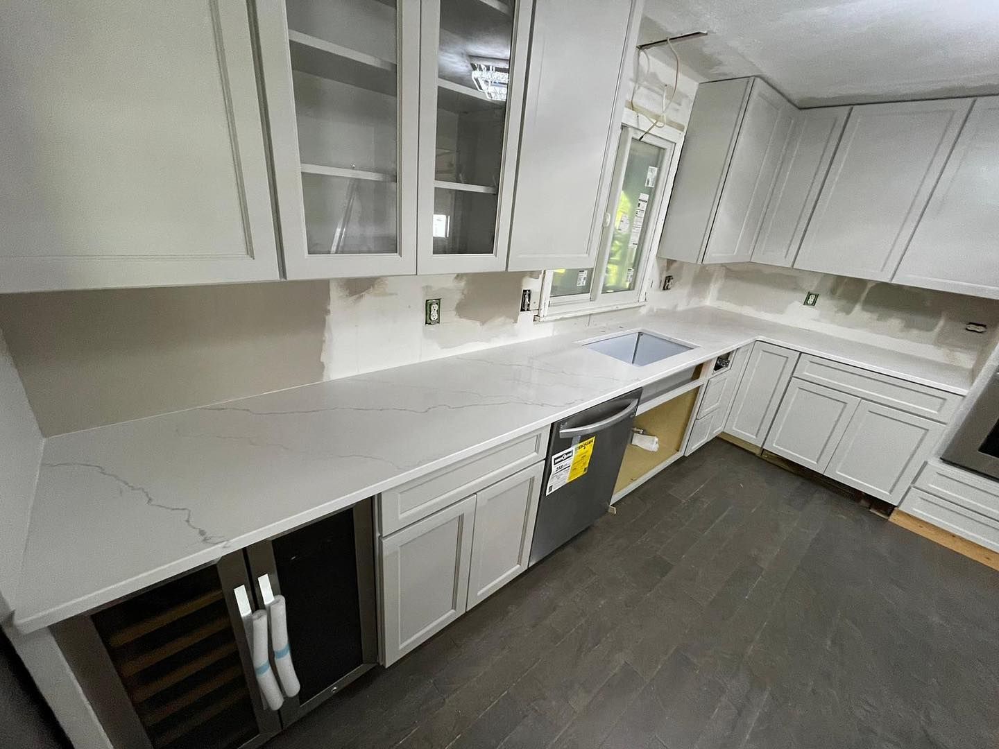 A kitchen with white cabinets and stainless steel appliances.