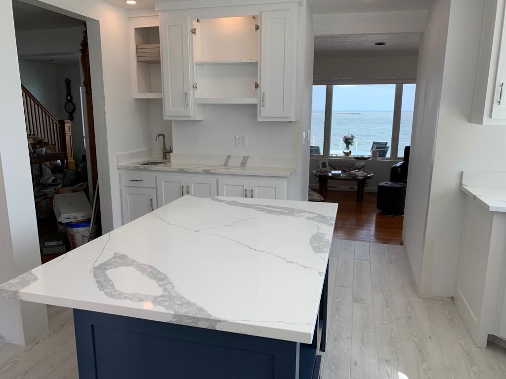 A kitchen with a large island in the middle of it.