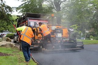 A group of men are working on a road.