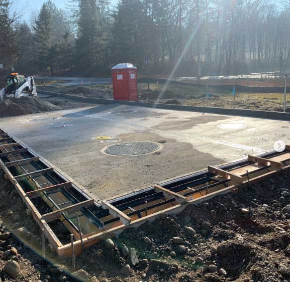 A construction site with a red toilet in the background