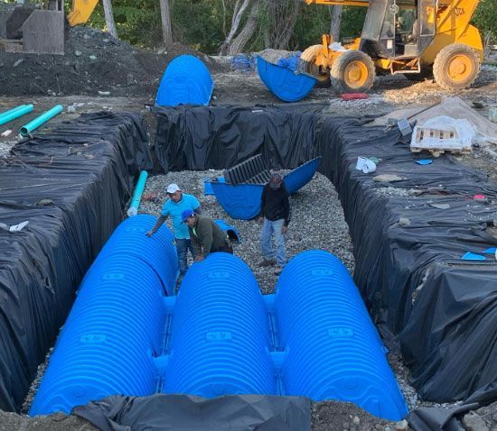 A group of men are working on a drainage system