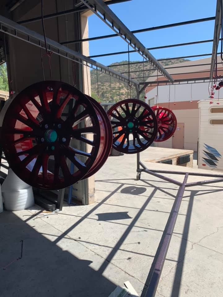 A bunch of red wheels are hanging from the ceiling