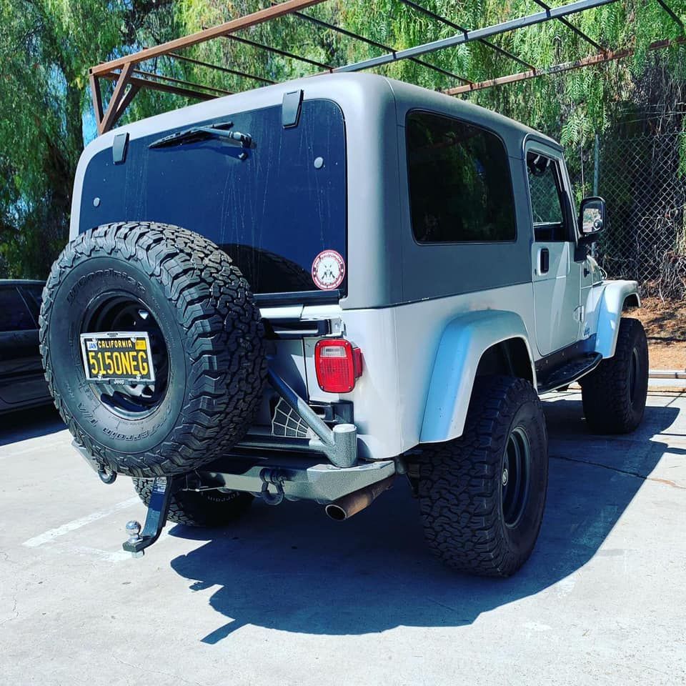 A white jeep with a california license plate