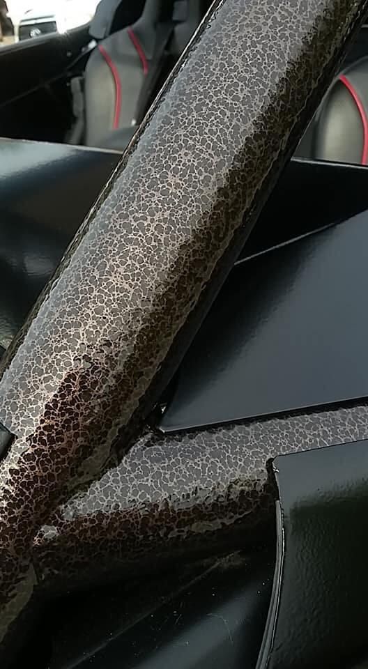 A close up of a metal bar on the side of a car.