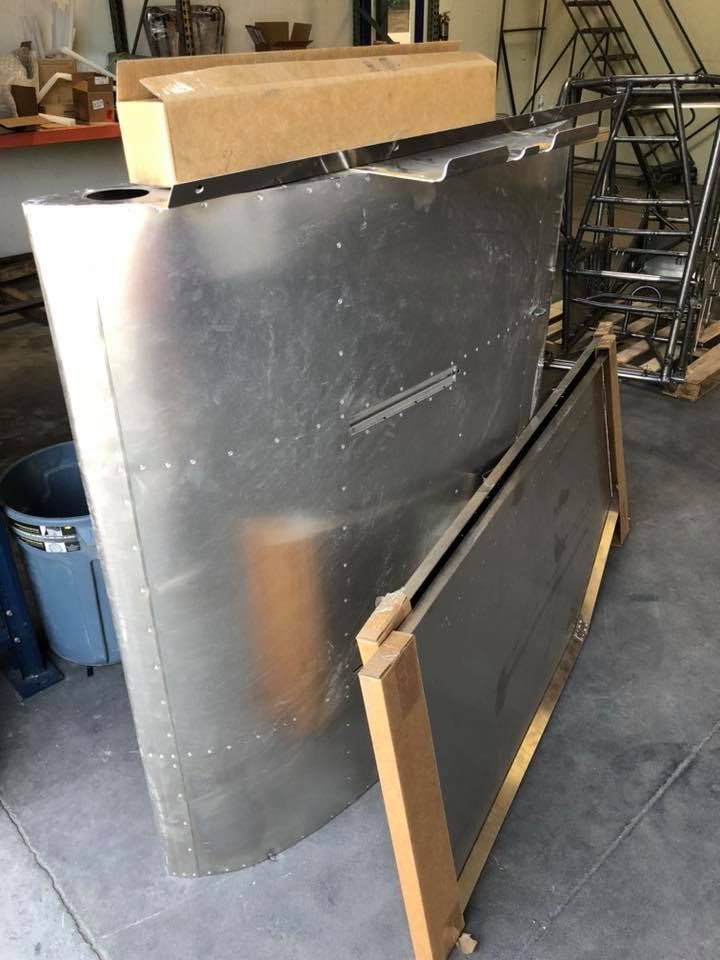 A large piece of metal is sitting on the floor next to a box.