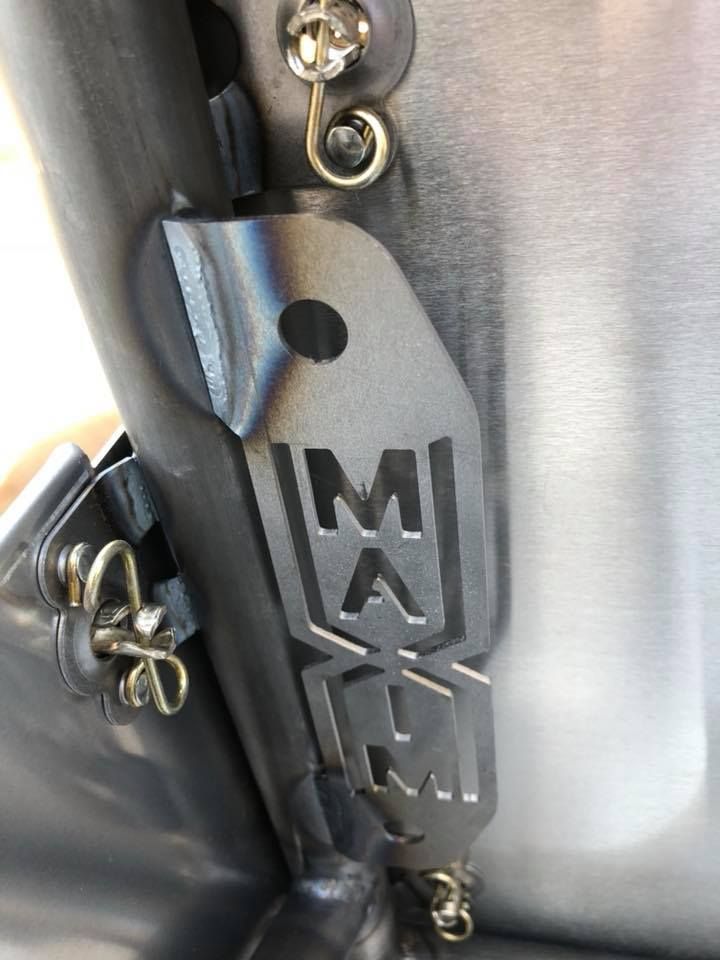 A close up of a metal object with the letter m on it.