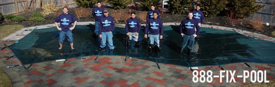 Group of people standing on a pool cover, wearing blue shirts, the words 