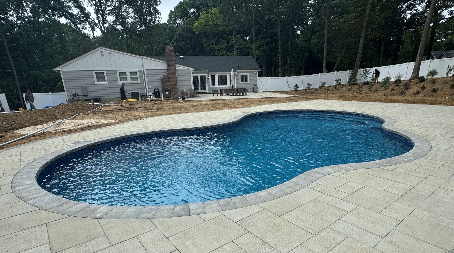 A large swimming pool in the backyard of a house