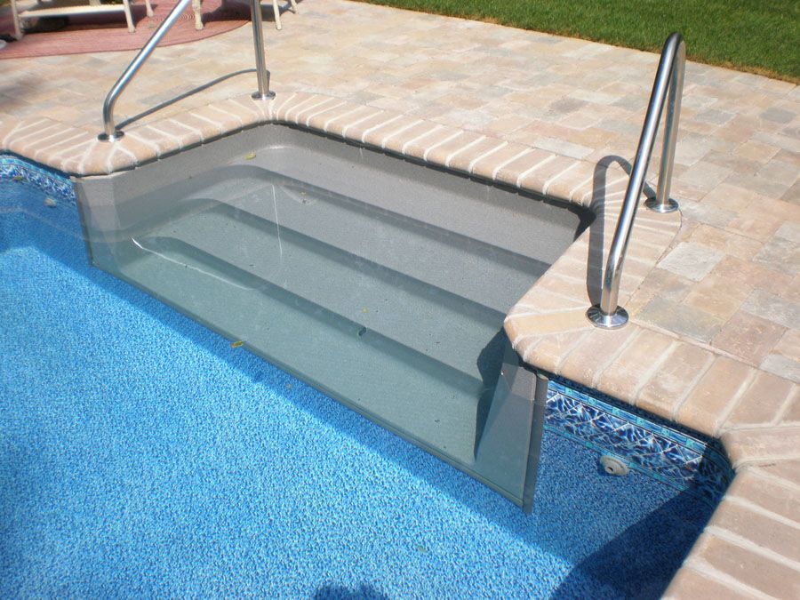 A swimming pool with stairs leading up to it