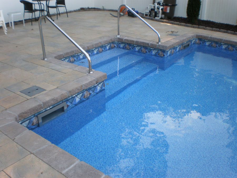 A swimming pool with stairs leading up to it
