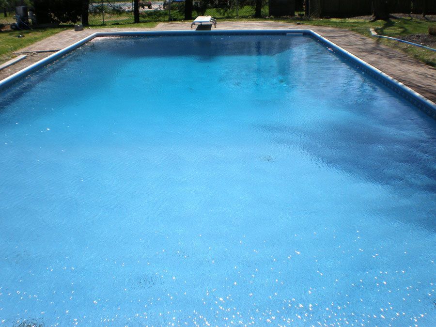A large swimming pool filled with blue water