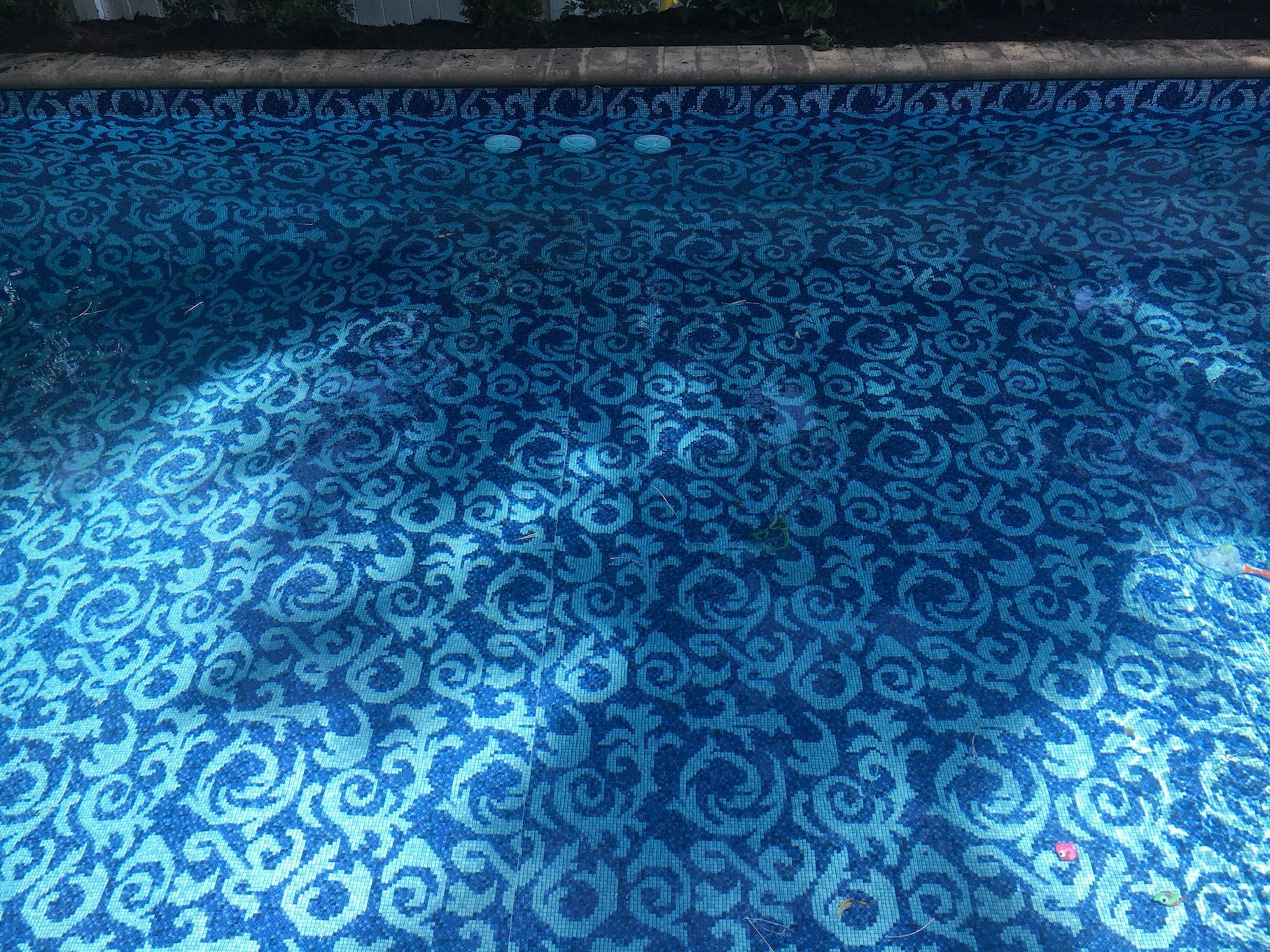 A swimming pool with a blue and white pattern on the floor.