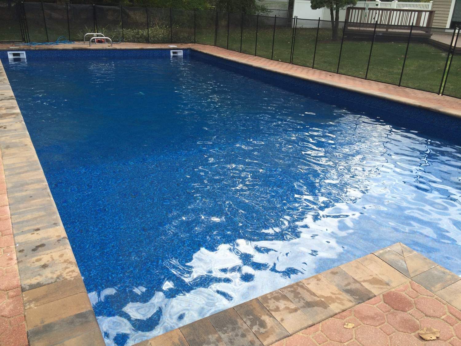 A large swimming pool with a fence around it