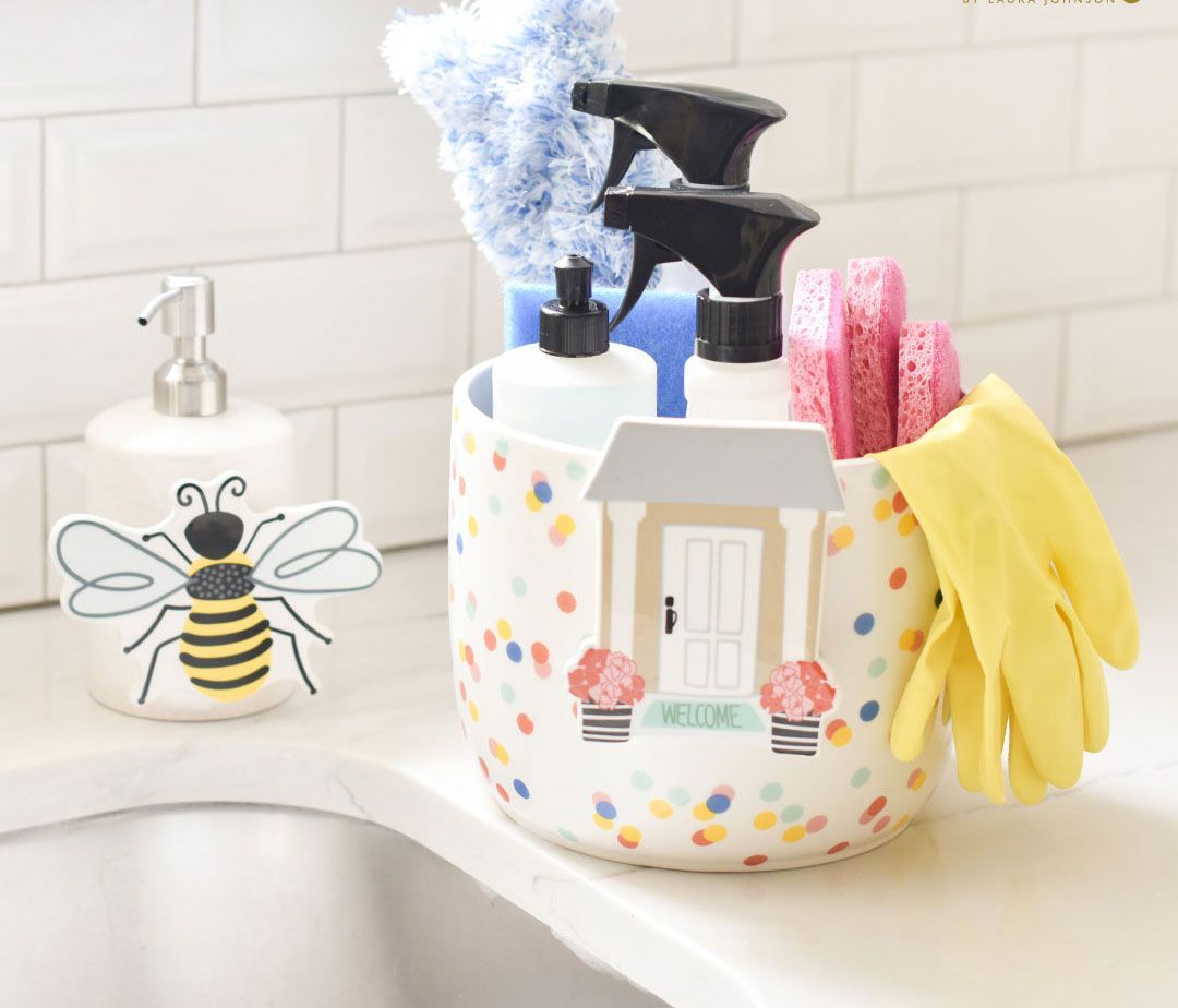 A bee soap dispenser sits next to a bowl filled with cleaning supplies