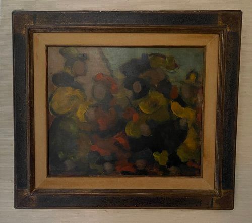 A painting in a wooden frame is hanging on a wall