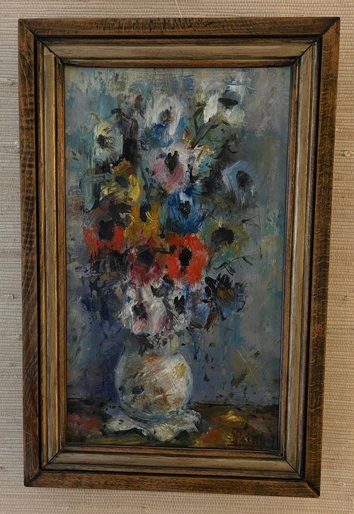 A framed painting of flowers in a vase on a table.