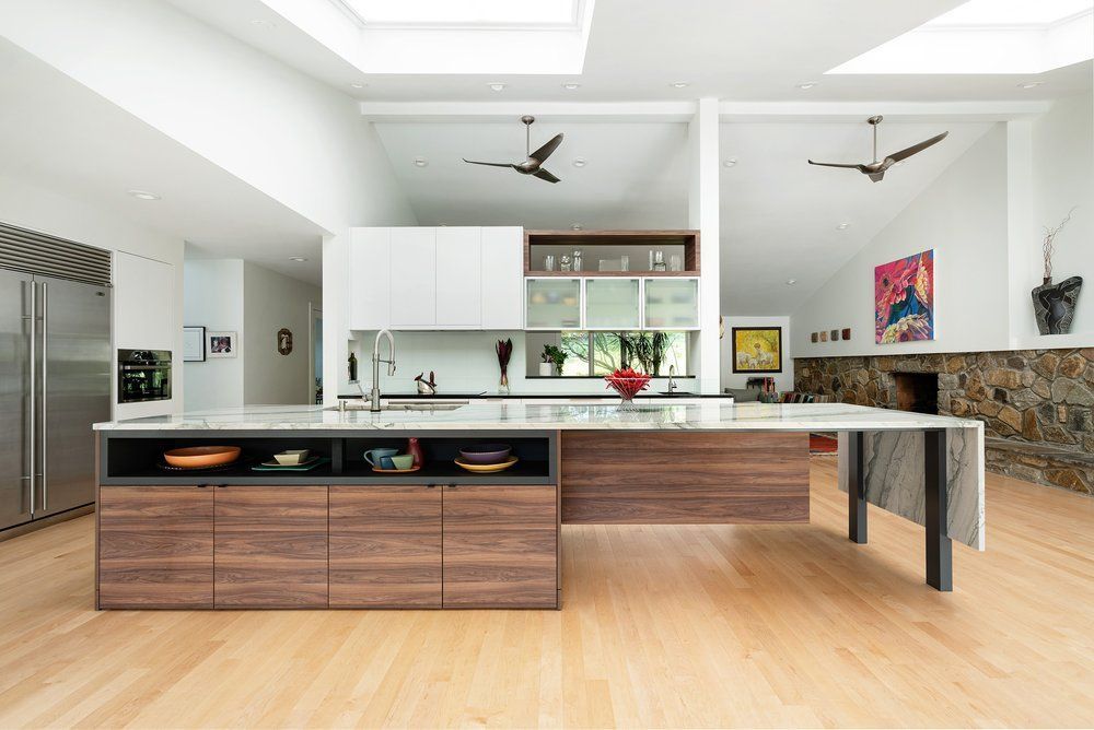 A kitchen with a large island and a ceiling fan
