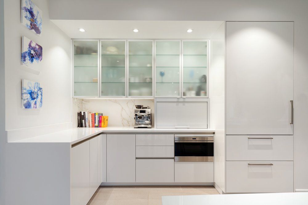 A kitchen with white cabinets and stainless steel appliances.