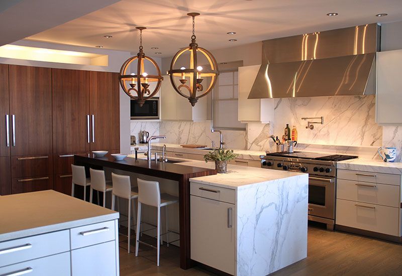 A kitchen with a large island and stainless steel appliances