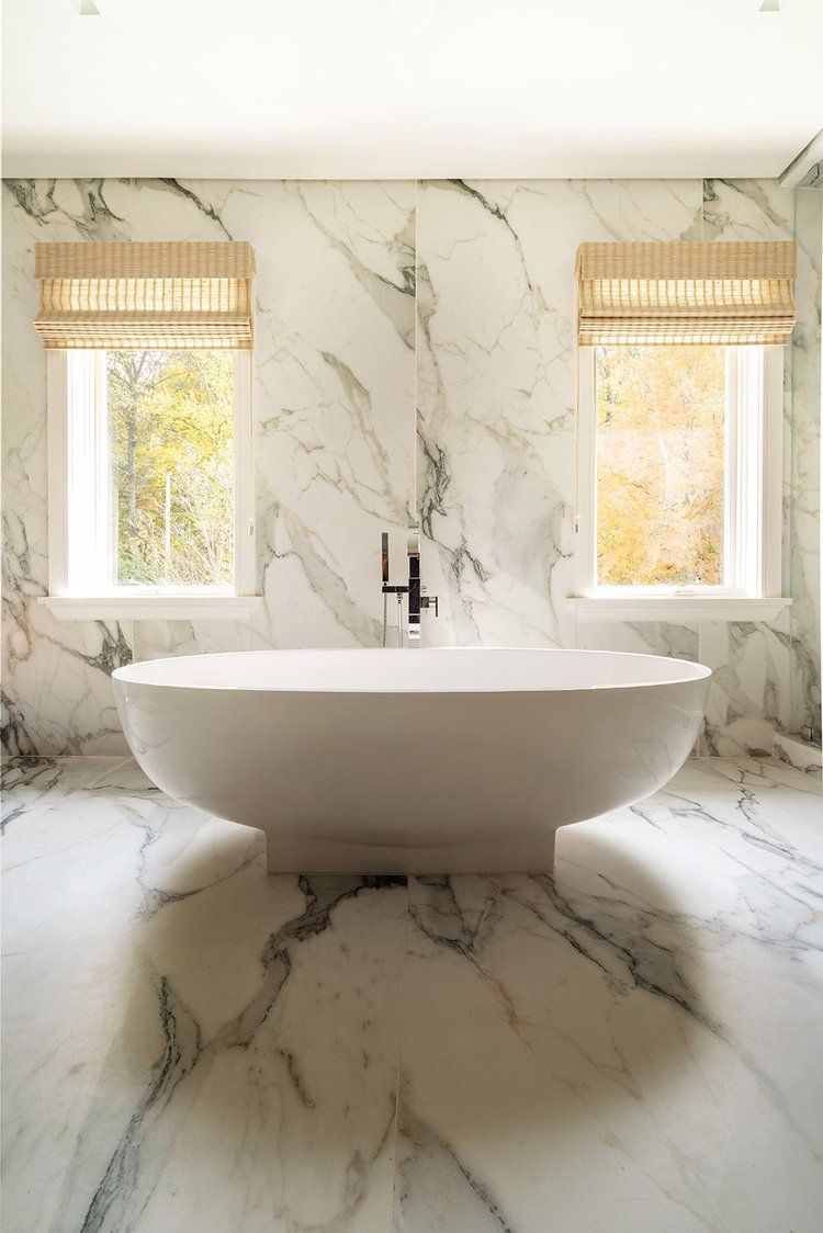 There is a bathtub in the middle of the bathroom.