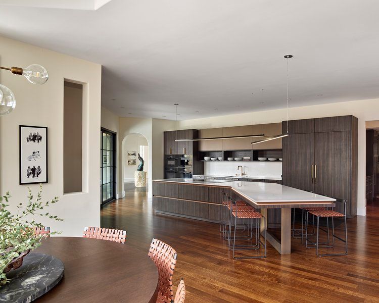 A kitchen with a table and chairs in it