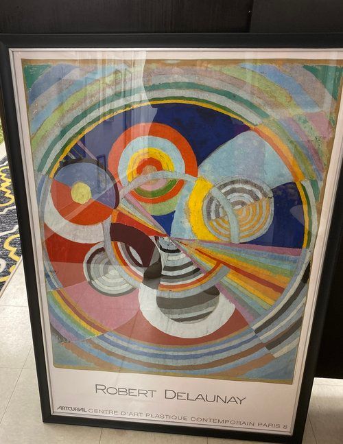 A framed colorful painting by robert delaunay