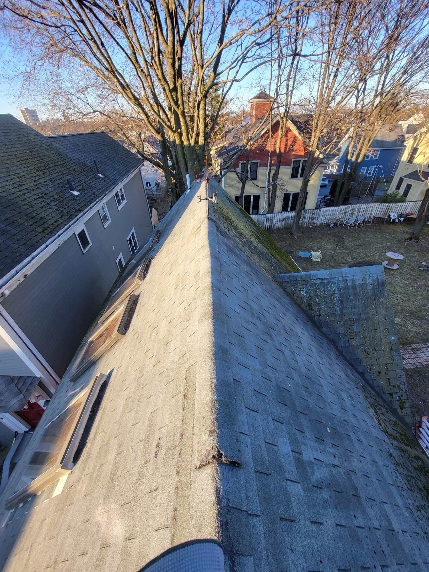 A person is standing on the roof of a house.