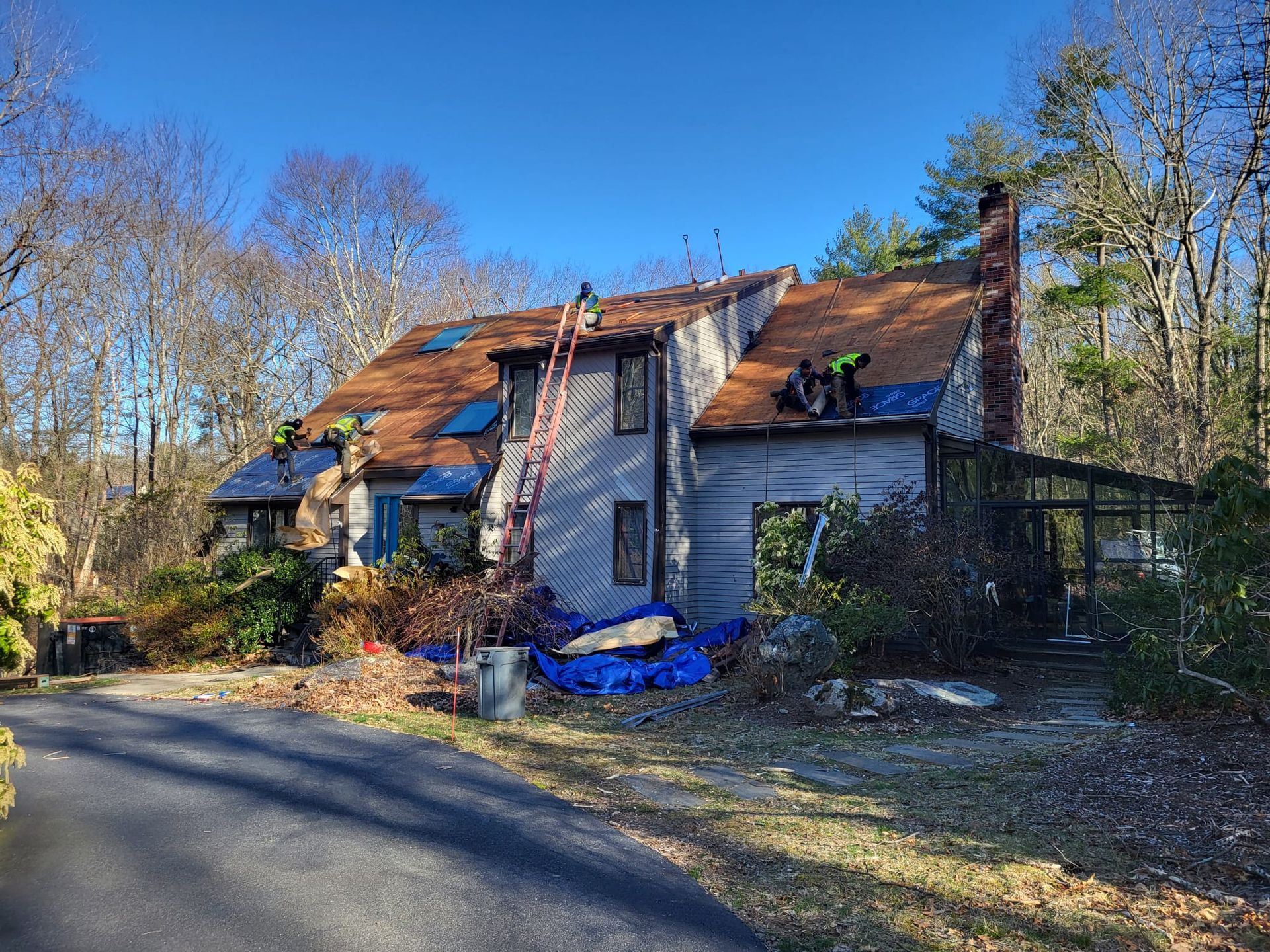 A large house with a roof that is being repaired.