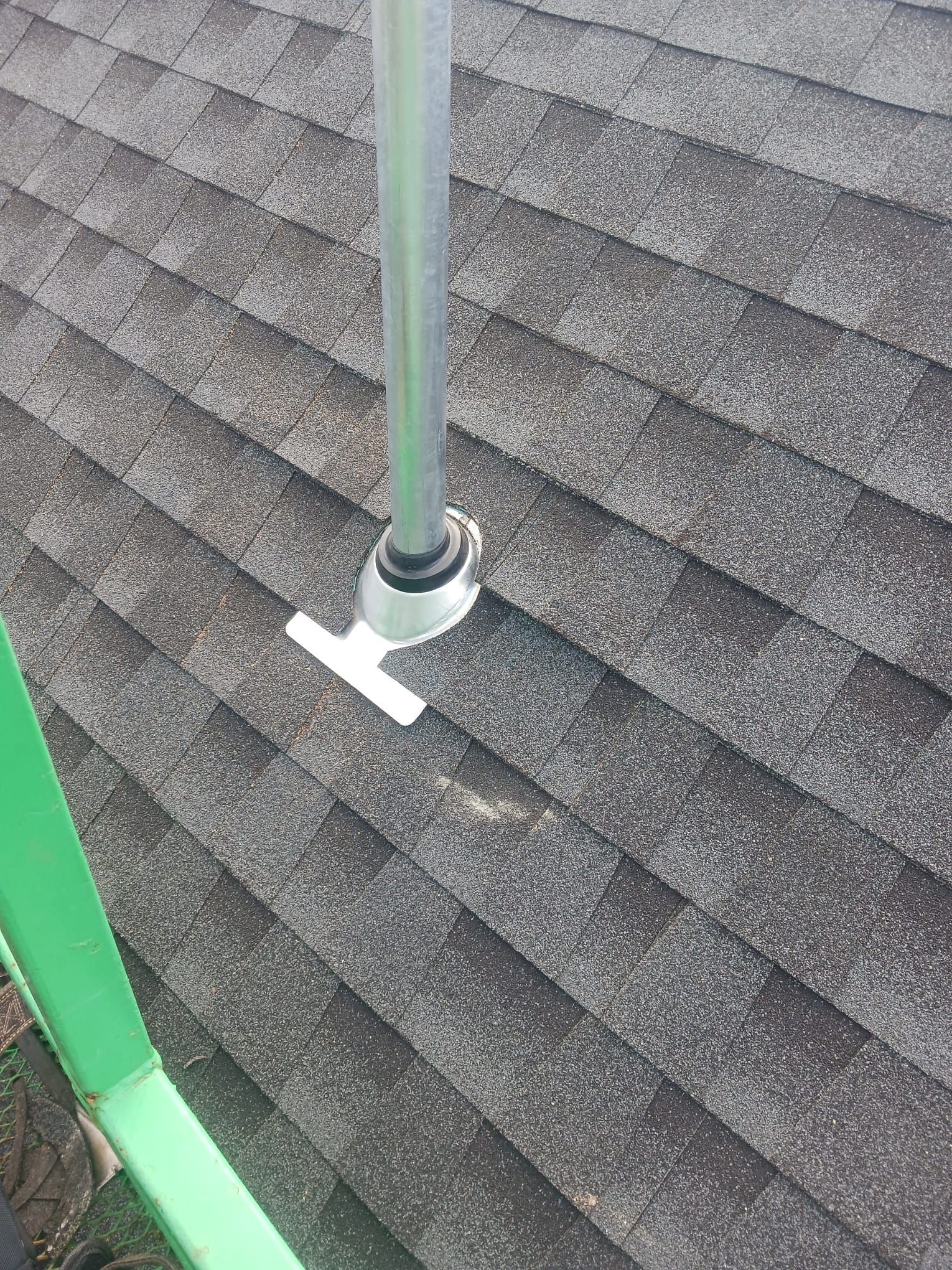 A pipe is sitting on top of a roof.