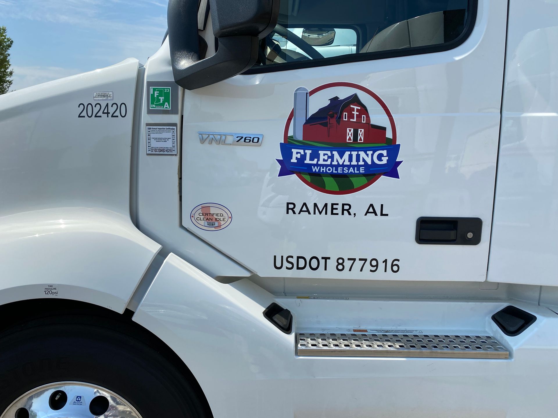 A white truck with the word fleming on the side of it
