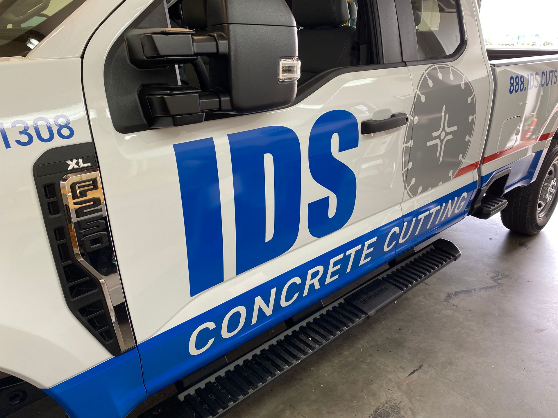 A white truck with the word IDS Concrete Cutting on the side.