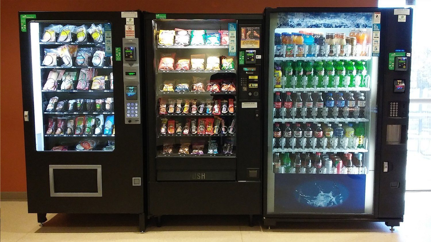 Three vending machines are lined up next to each other