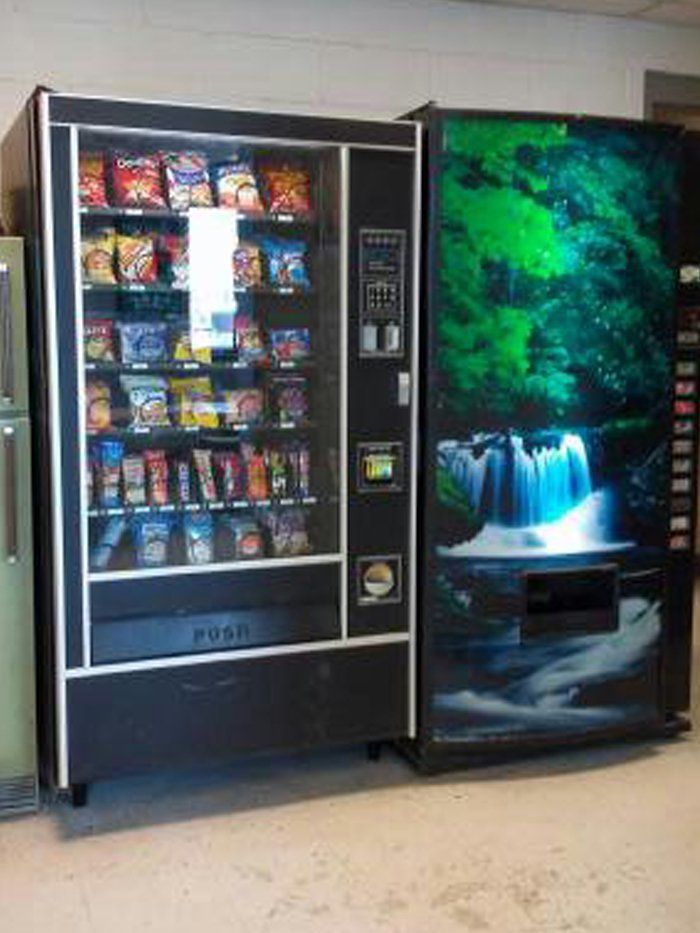 A vending machine with a picture of a waterfall on it