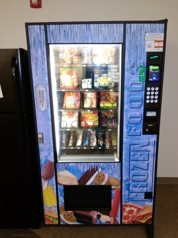 A vending machine that says frozen food on it
