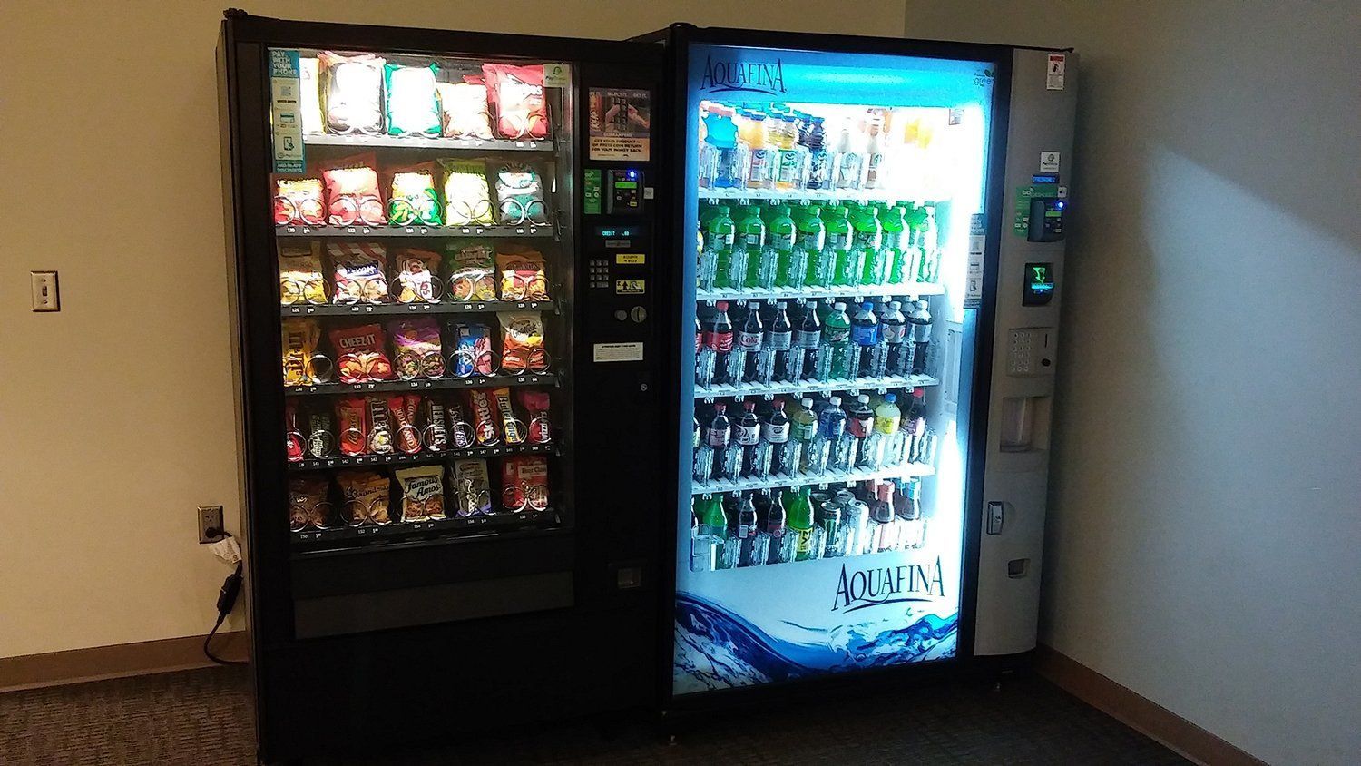 A vending machine that says aquafina on it
