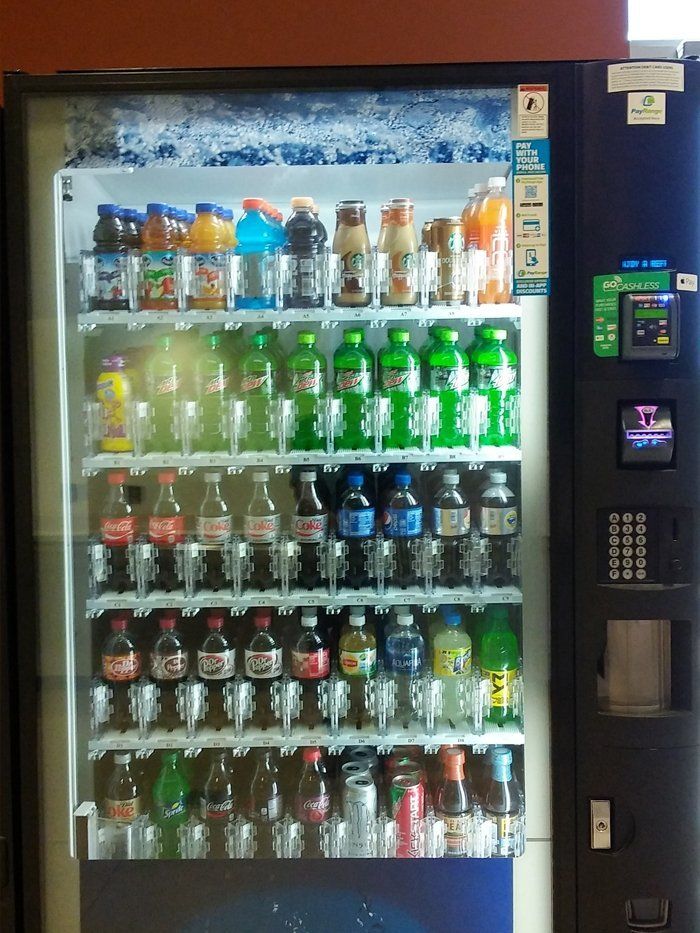 A vending machine filled with bottles of soda