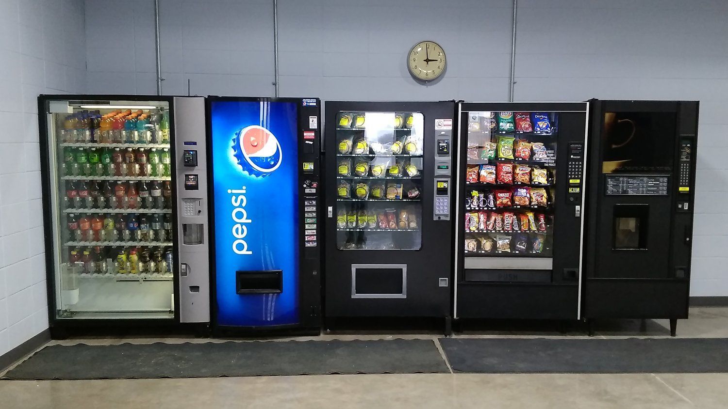 A row of vending machines including a pepsi machine