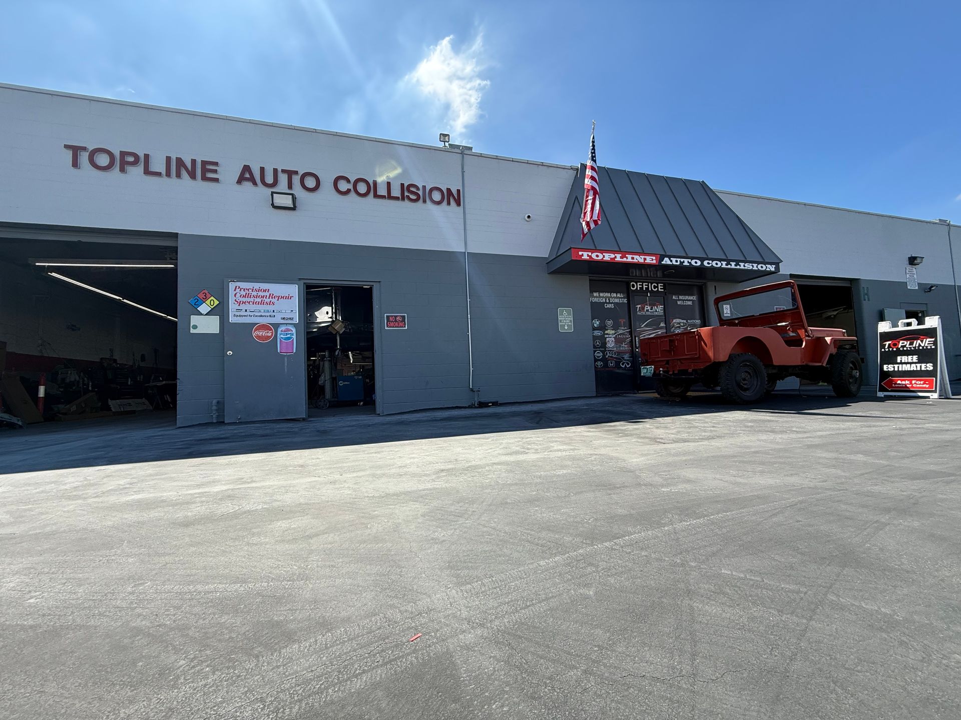Topline Auto Collision shop with a red Jeep parked in front on a sunny day.