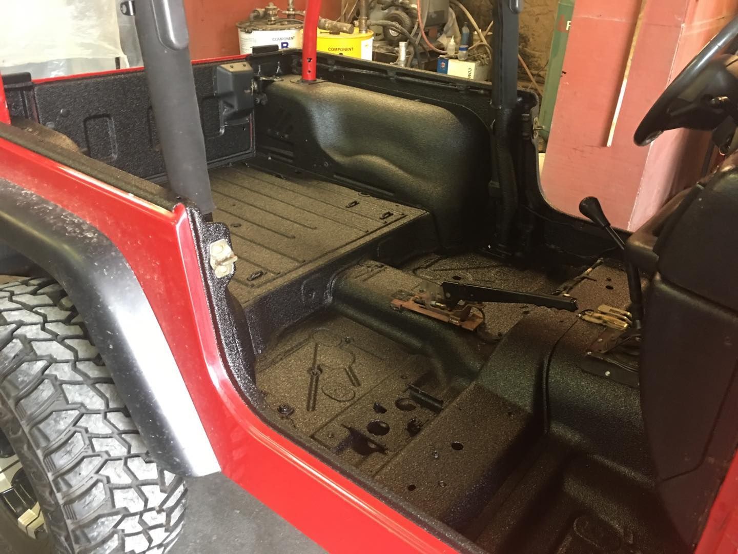 Red Jeep interior with black bedliner.
