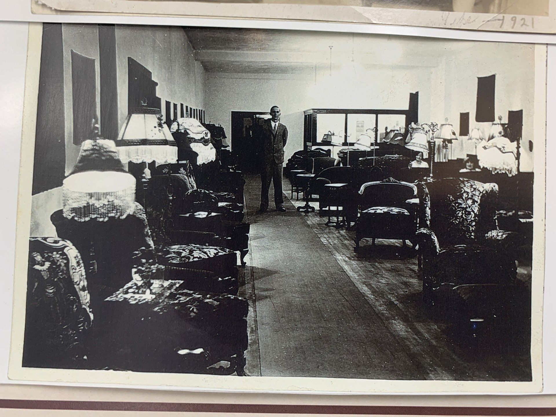 Black-and-white interior filled with rows of chairs and a central aisle, resembling a church or meeting hall