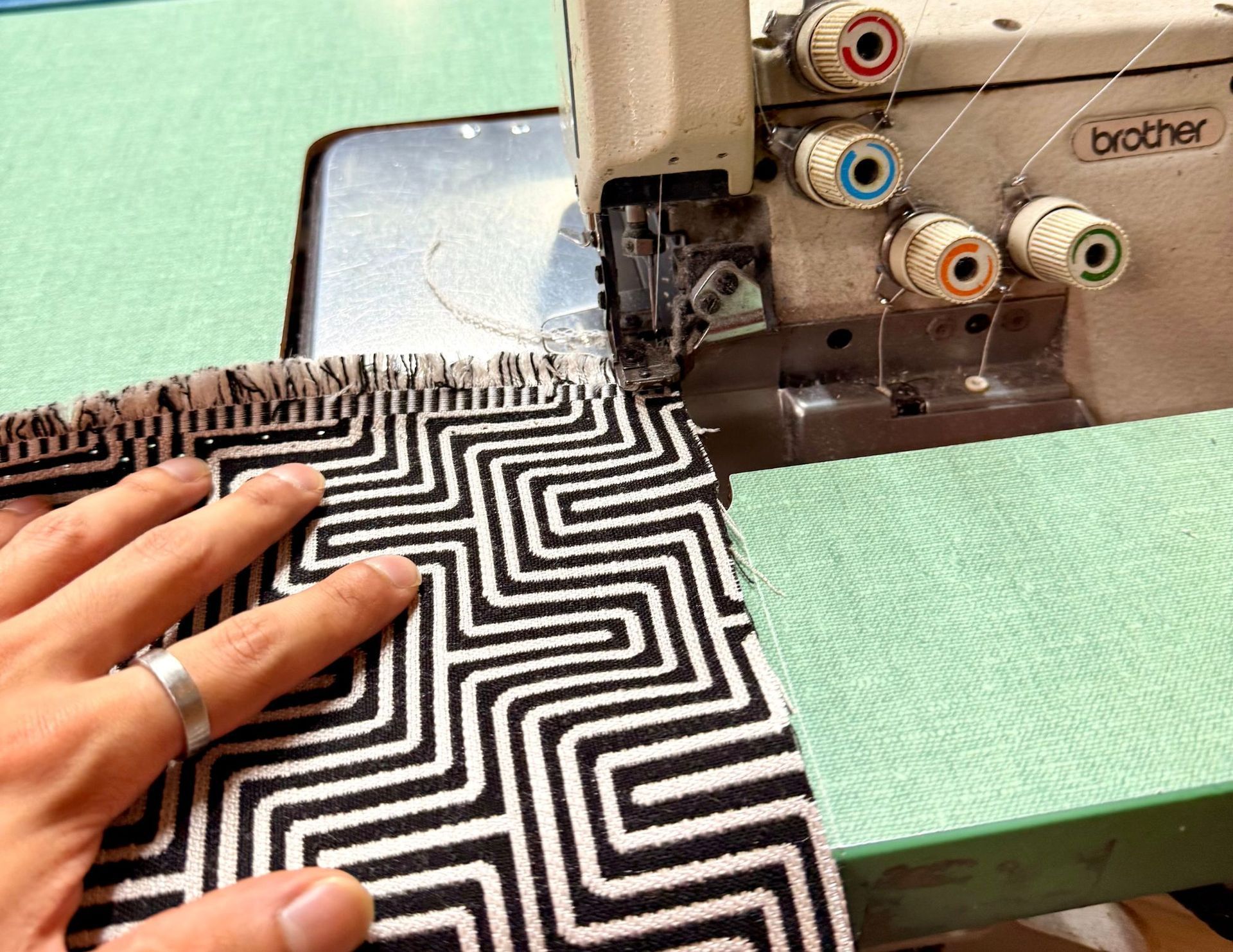 Hand sewing black-and-white geometric fabric on a Brother sewing machine