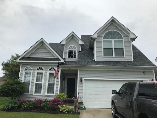 A house with a truck parked in front of it
