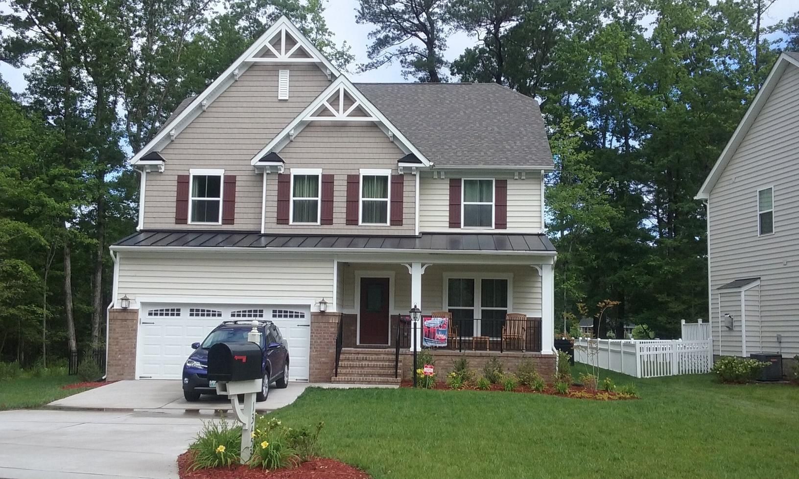 A house with a car parked in front of it