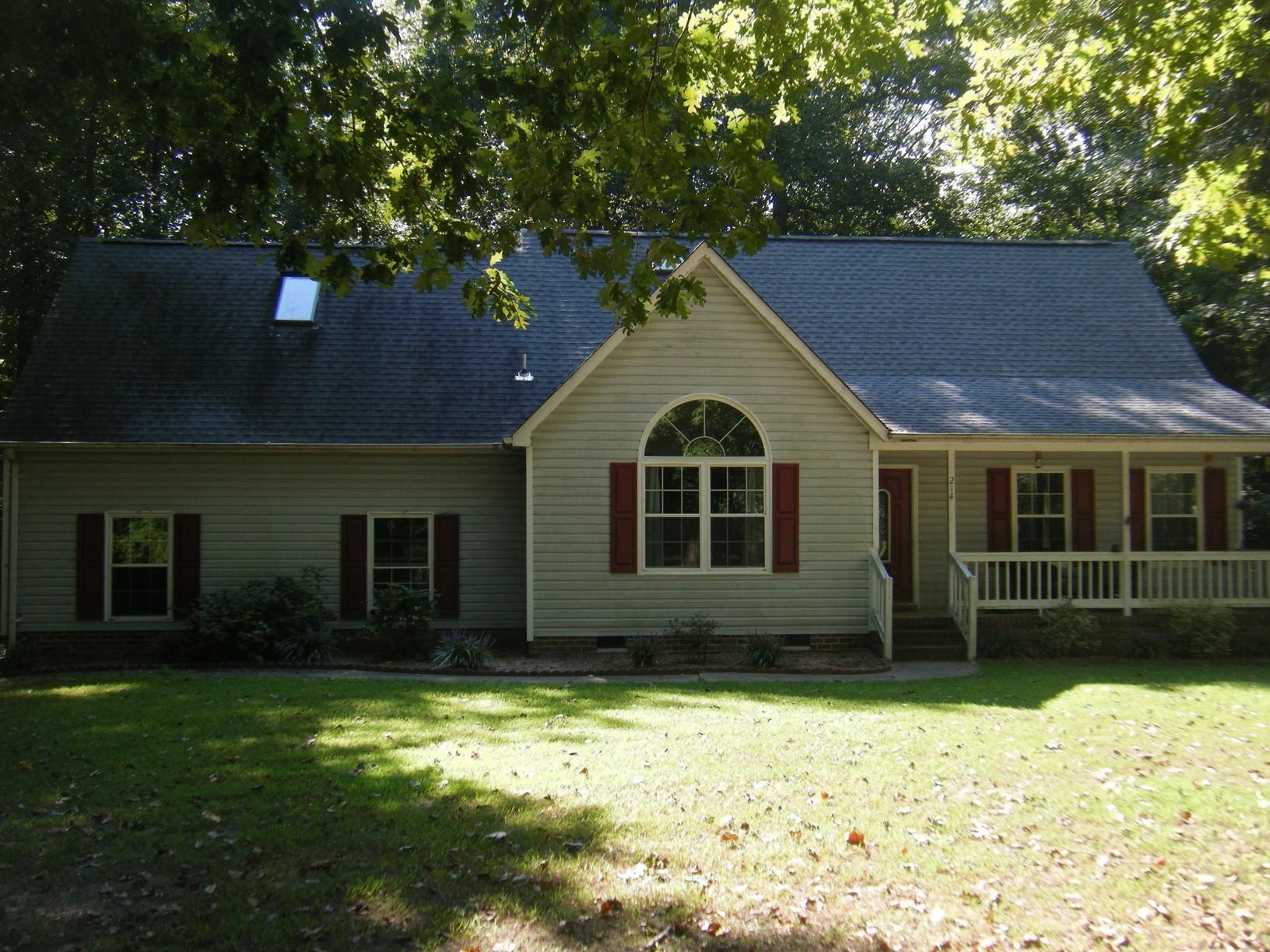 A house with a porch and a skylight on the roof