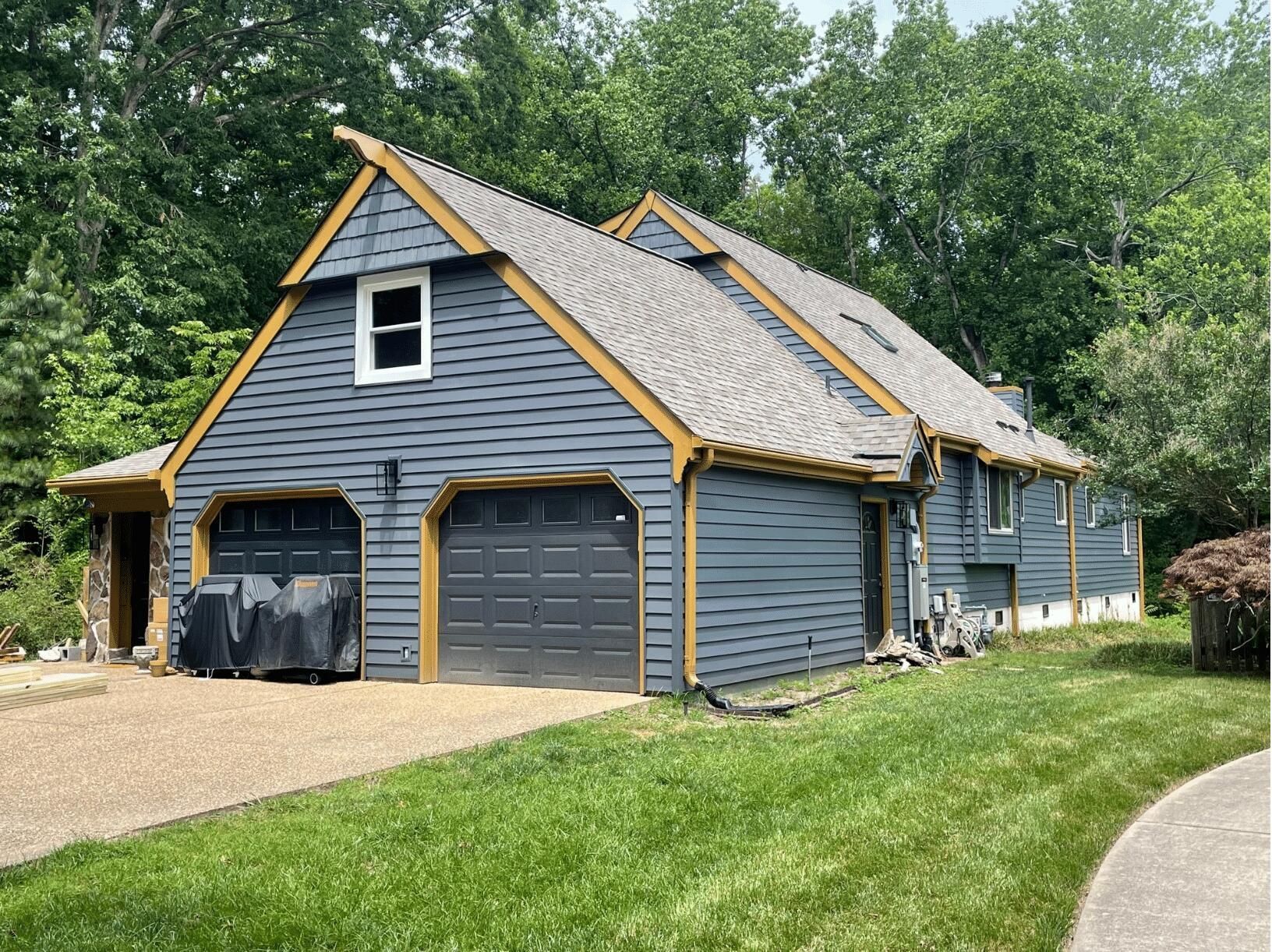 A large house with a garage and a driveway in front of it.