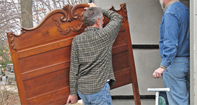 mover carrying a wooden ornament