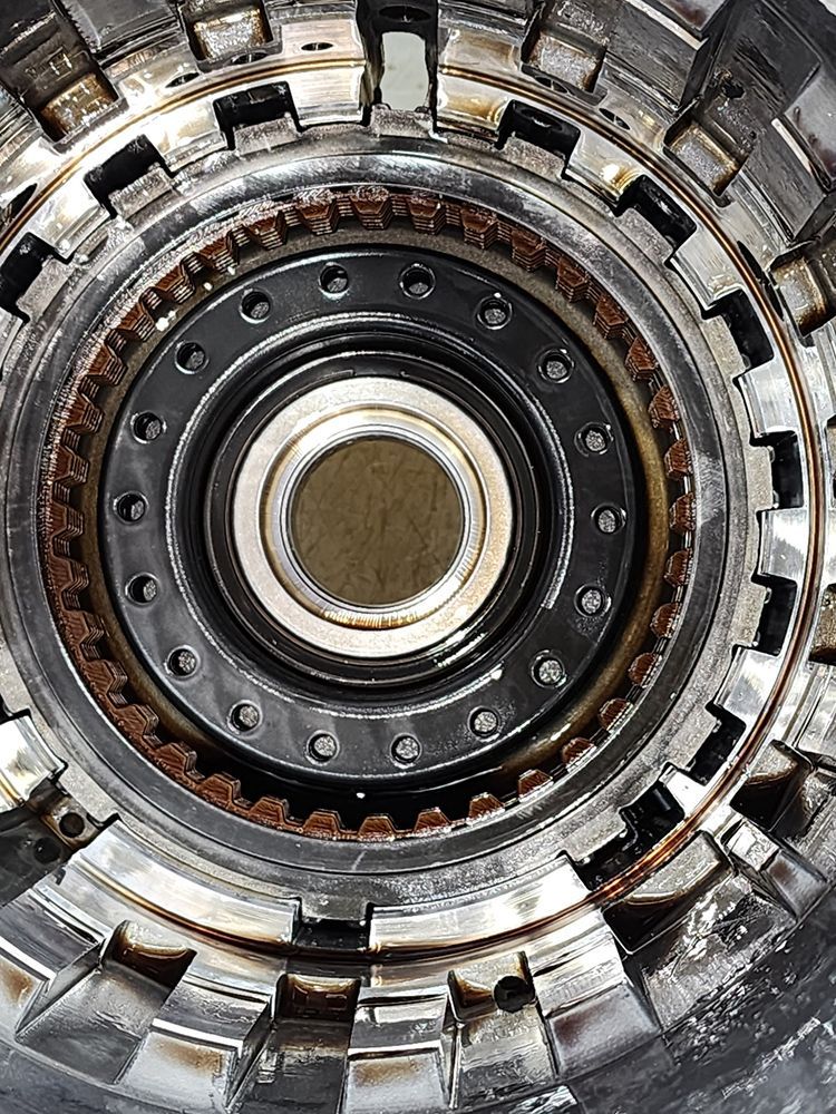Close-up view of an automobile transmission assembly showing internal gears and components.